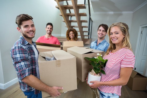 Person assessing boxes and furniture for a transparent storage quote